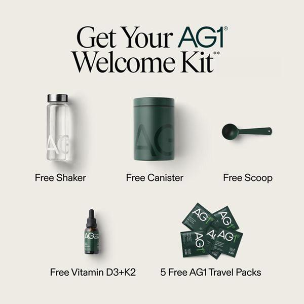 A clean, studio-lit flat lay presentation of the AG1 welcome kit, showcasing all included accessories and supplements to build perceived value.